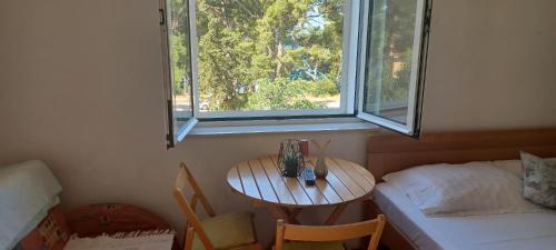 ein kleiner Raum mit einem Tisch und einem Fenster in der Unterkunft Studio apartman za 2 uz more in Makarska