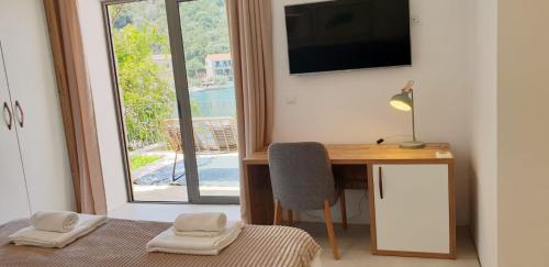 a room with a desk with a computer and a window at Augusta in Lastovo