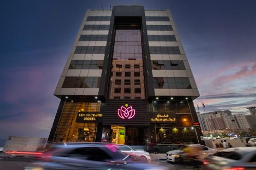 a building with a sign on the side of it at Lotus Grand Hotel in Dubai