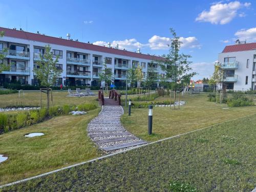 a walkway in a park in front of a building at Apartament Wilanow in Warsaw