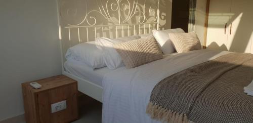 a bedroom with a large bed with white sheets and pillows at Augusta in Lastovo