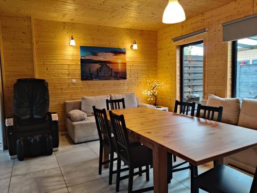 a dining room with a wooden table and chairs at Osada Jantar - Holiday in Jantar