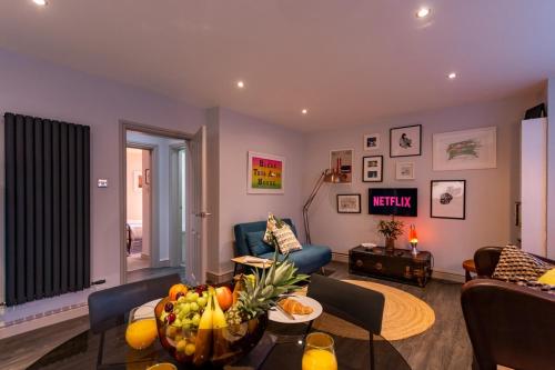 a living room with a couch and a table at Walpole Bay 2 bed Stunning Garden Apt By Adliv in Margate