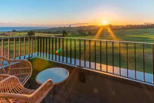 a balcony with chairs and a view of a golf course at Luxury Sea & North Foreland Golf View By Adliv in Kingsgate