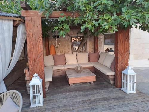 an outdoor living room with a couch and a table at Augusta in Lastovo