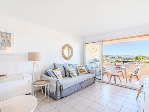 a living room with a couch and a view of the ocean at Apartment Les Marines-14 by Interhome in La Foux