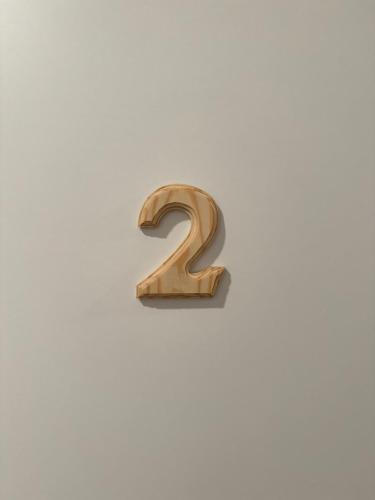 a wooden number two on a white wall at La Briga in Piaggia