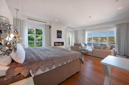 a bedroom with a large bed and a living room at Villa Oasis Del Mar in Camp de Mar