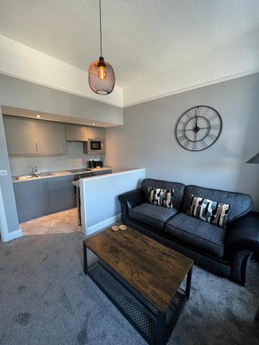 a living room with a couch and a coffee table at The Globe Apartments in Cockermouth
