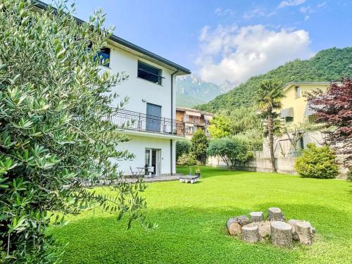 a house with a green yard with rocks at Apartment DaNina by Interhome in Abbadia Lariana