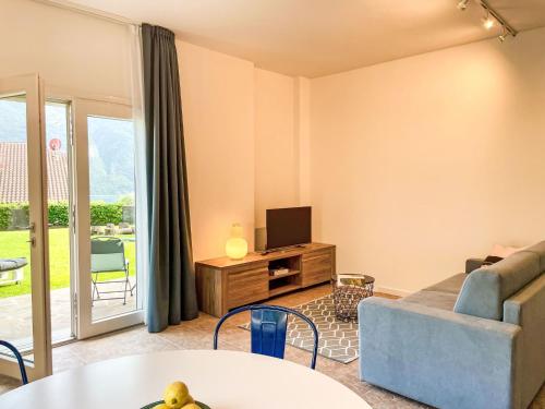 a living room with a couch and a tv at Apartment DaNina by Interhome in Abbadia Lariana