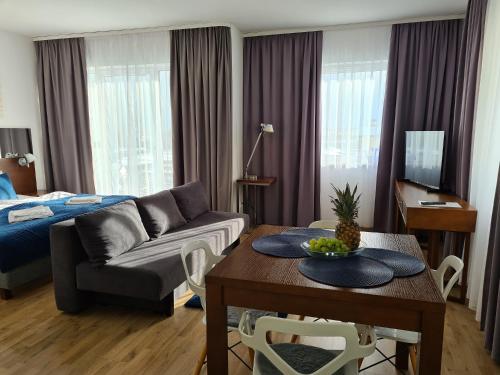 a living room with a couch and a table at ATRIUM Sarbinowo Na Fali in Sarbinowo