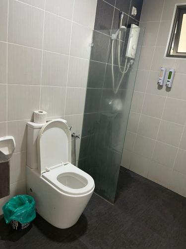 a bathroom with a toilet and a shower stall at Evo Green Tea 25 with Netflix in Bandar Baru Bangi