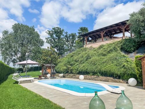 a swimming pool in a yard next to a building at Apartment Nonno by Interhome in Portacomaro