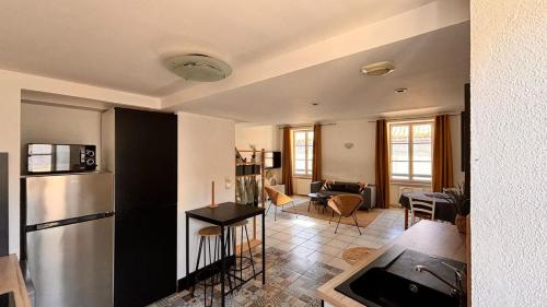 une cuisine avec un réfrigérateur et un salon dans l'établissement Charming Carcassonne Duplex, à Carcassonne