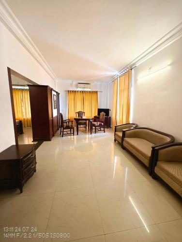 a large living room with couches and a table at Vyshak International in Payyannūr