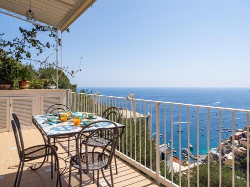 a table and chairs on a balcony overlooking the ocean at Casa Vittorina - De Vivo Realty Positano in Positano