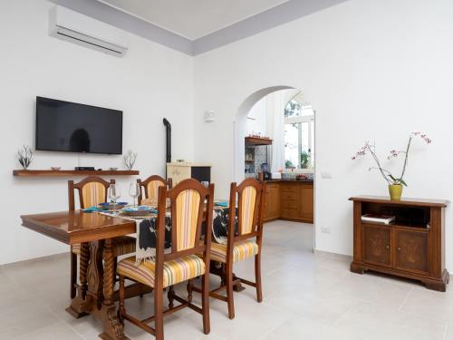 a dining room with a wooden table and chairs at Casa Vittorina - De Vivo Realty Positano in Positano