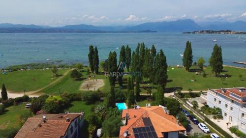 an aerial view of a park next to the water at Villa Bionda- unique gem with private pool on Lake Garda in Sirmione