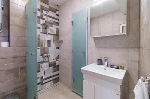 a bathroom with a sink and a shower at Modern 1-Bedroom Apartment with Free Parking in Plovdiv