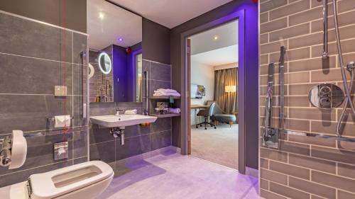 a bathroom with a toilet and a sink at Holiday Inn Manchester - City Centre by IHG in Manchester