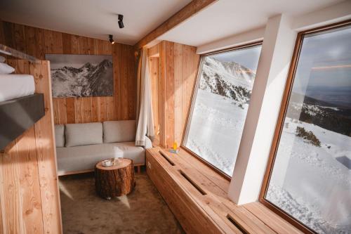 a room with a bed and a window at Horská Chata pod Soliskom in Vysoké Tatry