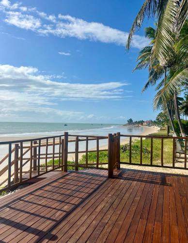 a wooden deck with a view of the beach at Muriú RN - Savage Beach House in Ceará-Mirim