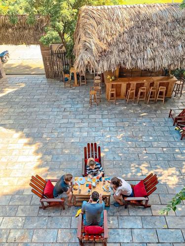 a group of people sitting around a table at Tam Coc Central Bungalow-Hostel in Vũ Lâm