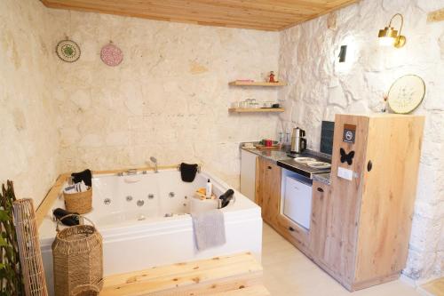 a bathroom with a bath tub and a kitchen at Kandybos Eco Farm Village in Kas