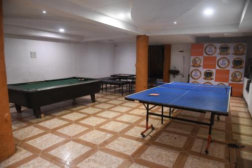 a room with two tables and a pool table at Hill Forest Resort in Lonavala