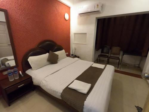 a bedroom with a large bed in a room at Hill Forest Resort in Lonavala