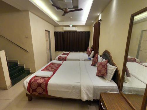 a bedroom with two beds and a ceiling at Hill Forest Resort in Lonavala