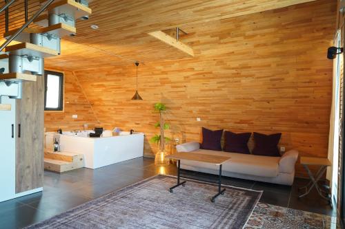 a living room with a couch and a wooden wall at Kandybos Eco Farm Village in Kas