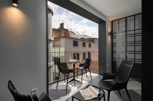 a balcony with chairs and a table on a balcony at Savoy Insular VI by An Island Apart in Funchal