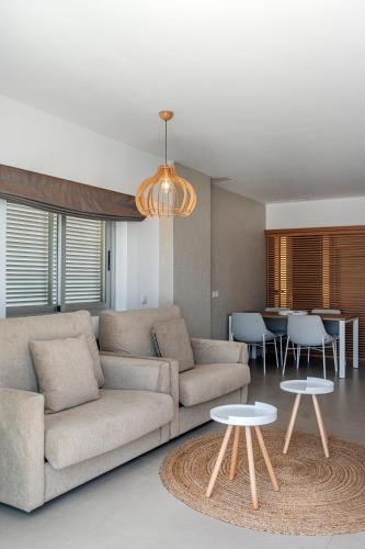 a living room with a couch and two tables at Bordoy Cosmopolitan in Playa de Palma