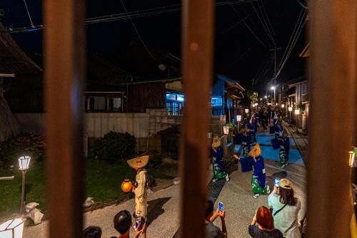 a group of children playing in a playground at night at NIPPONIA Sado 佐渡相川 金山町 in Sado