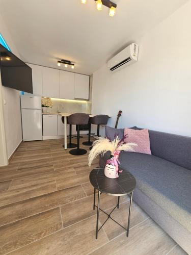 a living room with a couch and a table at Rita Apartments in Makarska