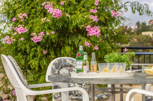 a table with two bottles of alcohol sitting on it at Cliffside Villa in Tala