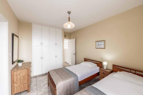 a bedroom with two beds and a cabinet at Cliffside Villa in Tala