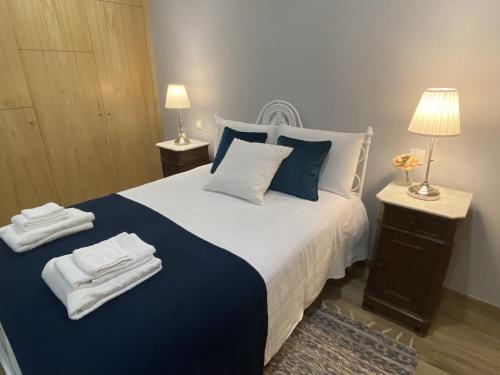 a bedroom with a large bed with towels on it at Quinta de Souto Velho in Terras de Bouro