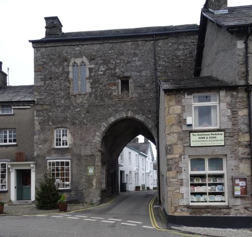 an old stone building with an arch over a street at Kents Bank Holiday - Pet Friendly with Bay Views in Grange Over Sands
