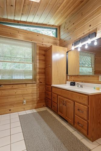 a bathroom with a sink and a window at Torch Lake House Central Lake in Central Lake