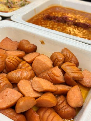 two plastic trays filled with food on a table at President Hotel Montfort in Ždiar