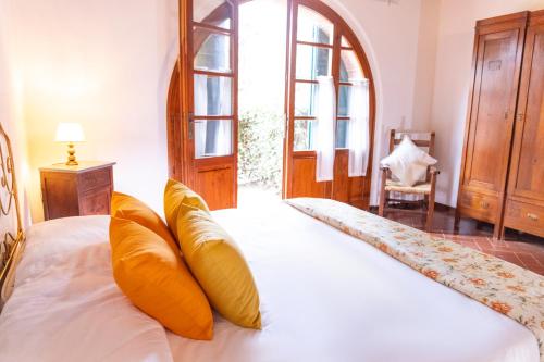 a bedroom with a bed with orange pillows on it at Borgo Il Poggio Agriturismo in Montaione