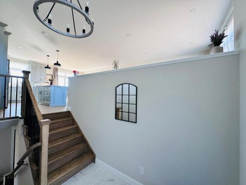 a staircase in a home with a white wall at Luxury Home 2 mins drive to Saugeen Shores beach in Port Elgin