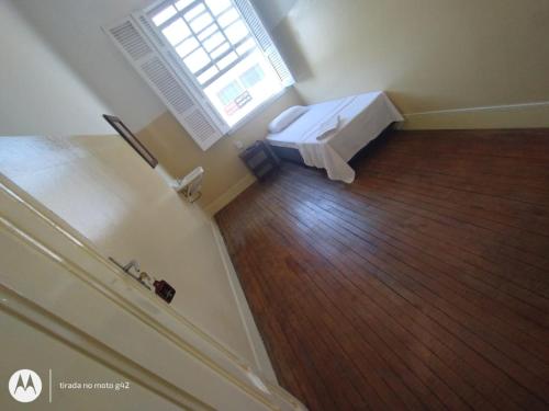 an empty room with a bed and a window at Hotel Central in Araçatuba