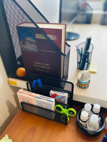 a black container with scissors and other items on a desk at Appartement intégral , Nanterre La Défense Paris , propre à côté de tous commodité in Nanterre