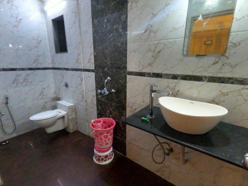 a bathroom with a sink and a toilet at Hill Forest Resort in Lonavala