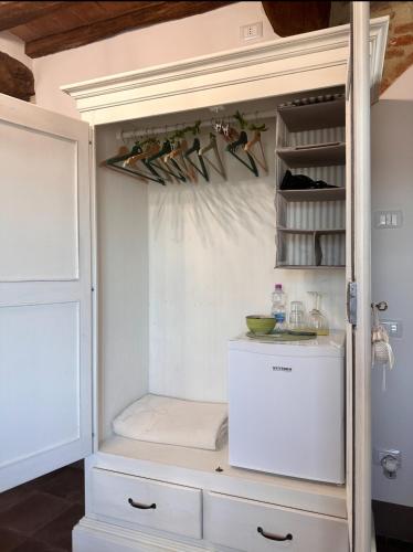 a kitchen with a white cabinet with a shelf at Antica Torre del Borgo in Certaldo