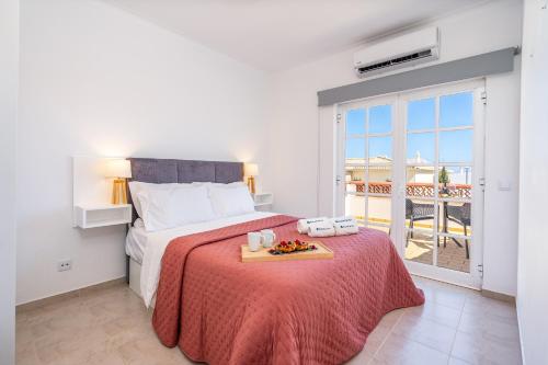 a bedroom with a bed with a tray of food on it at Host Wise - Spacious Family House with Garden in Lagos